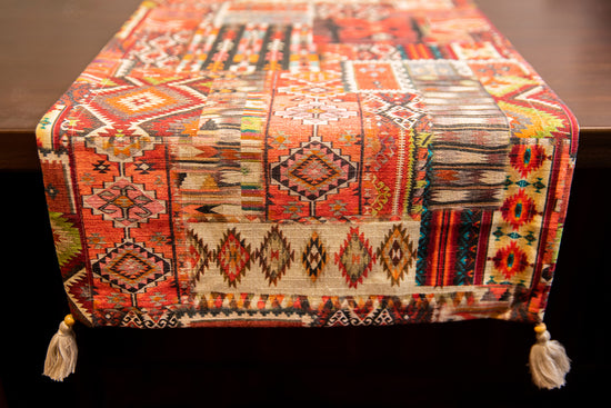 Red printed runner with embroidery and tassels.