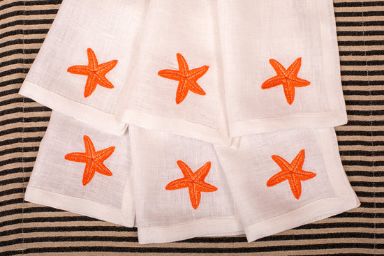 White linen embroidered cocktail napkin.