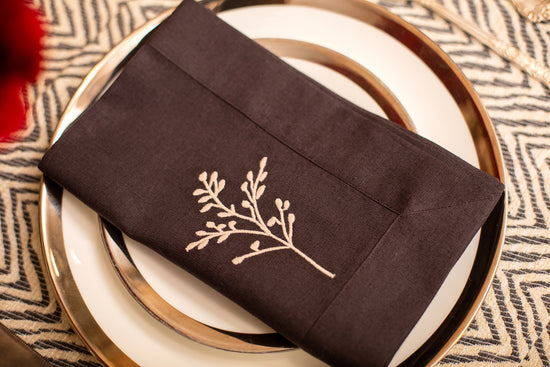 Herringbone placemat and navy blue linen embroidered napkin.
