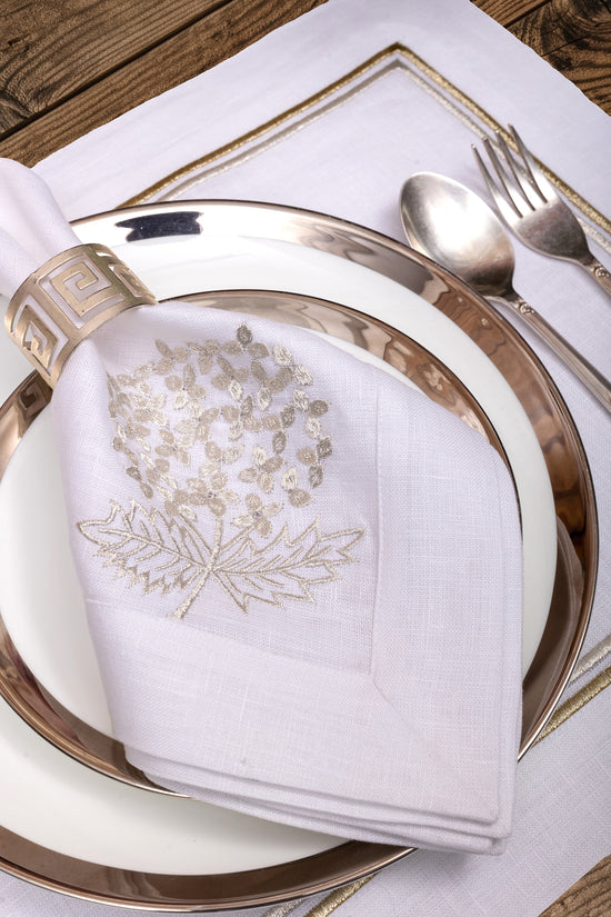 White linen placemats and napkins with gold hydrangea.