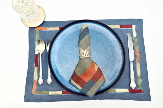 Slate blue linen placemats with printed linen napkins.