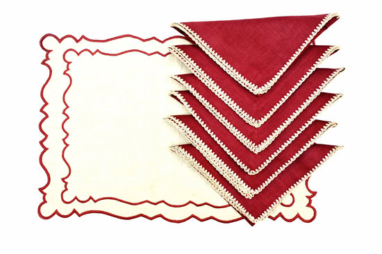Natural linen placemats with maroon linen embroidered napkins.