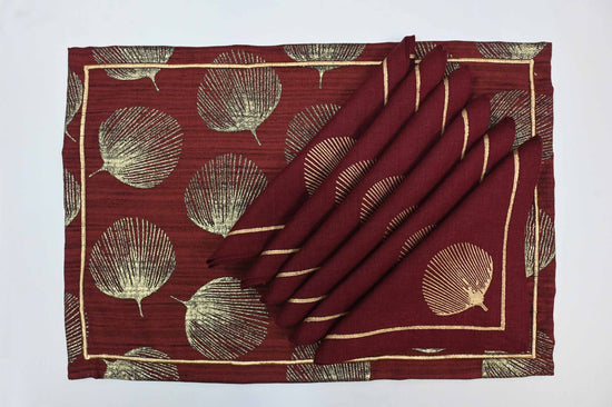 Maroon printed linen placemats with linen napkins.