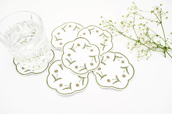 White linen round embroidered coasters.