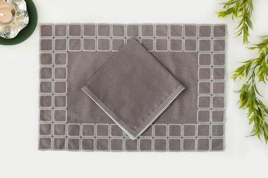 Grey linen embroidered placemats with matching linen napkins.