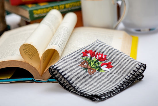 Striped linen cocktail napkins with floral embroidery.
