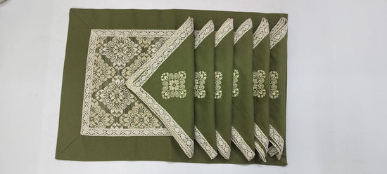 Green printed placemats with green embroidered linen napkins.