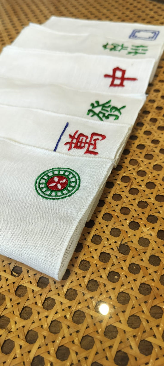 White linen mahjong assorted cocktail napkins.