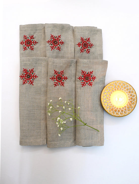 Linen christmas cocktail napkins with embroidered snowflake.