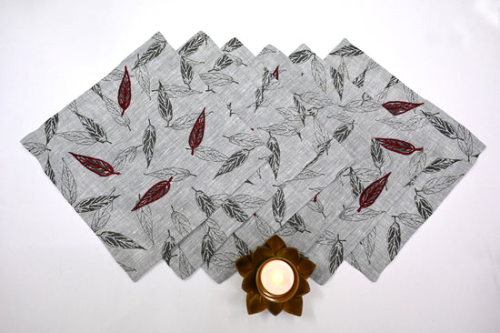 Grey printed linen cocktail napkins with red embroidery.