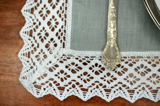 Grey linen placemats and napkins with white lace