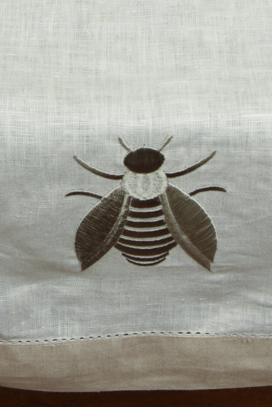 White linen runner with beetle embroidery