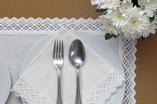 White lace on white linen mats & napkins
