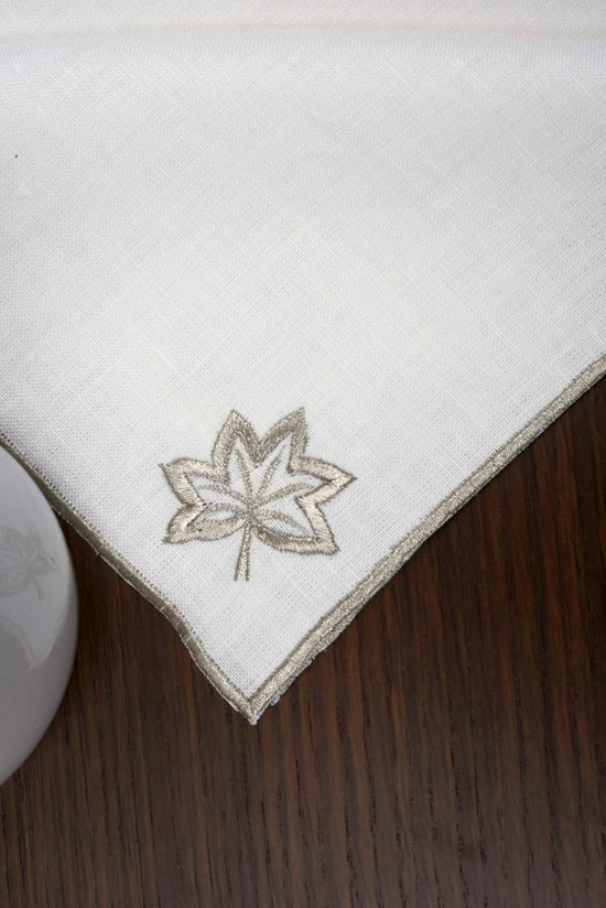 White linen cocktail napkins with gold maple leaf embroidery