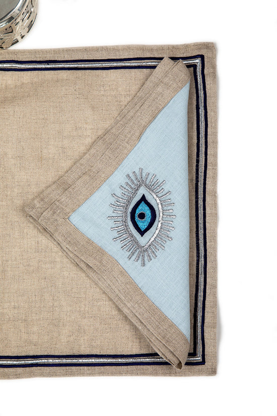 Natural linen placemats with embroidery and embroidered powder blue napkins.