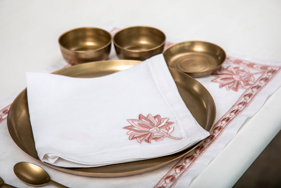 White linen  dinner napkins with lotus embroidery.