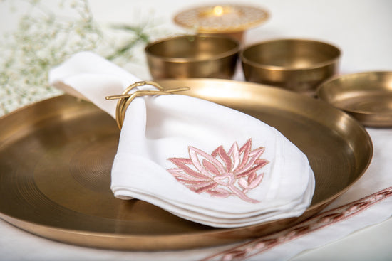 White linen  dinner napkins with lotus embroidery.