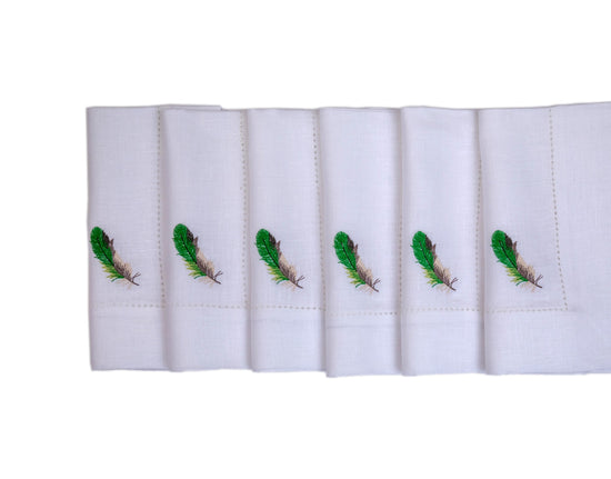 White linen  with embroidered cocktail napkins.