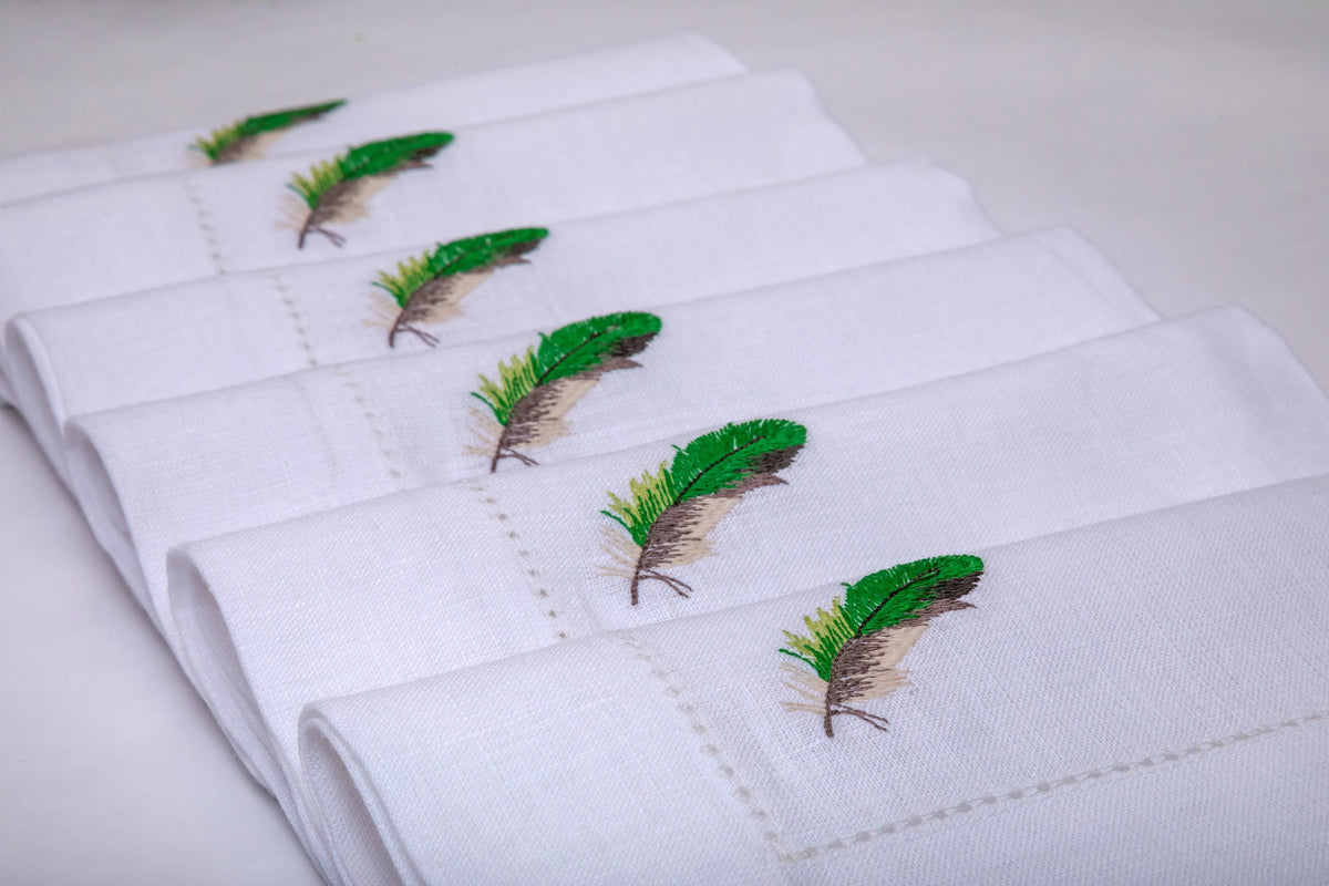 White linen  with embroidered cocktail napkins.