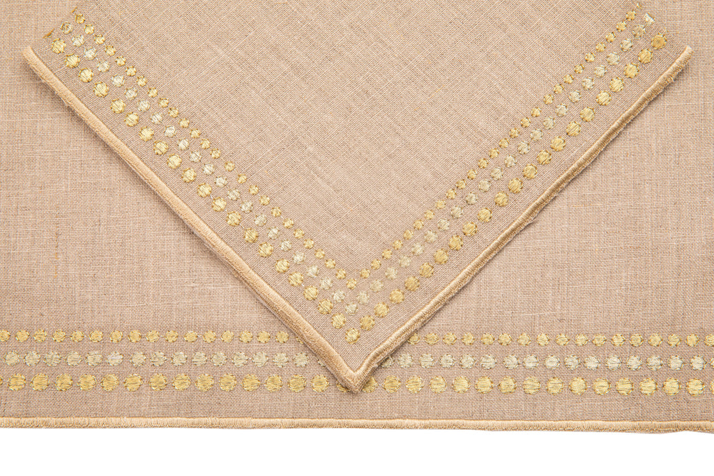 Natural linen placemats and  napkins with delicate  gold embroidery.