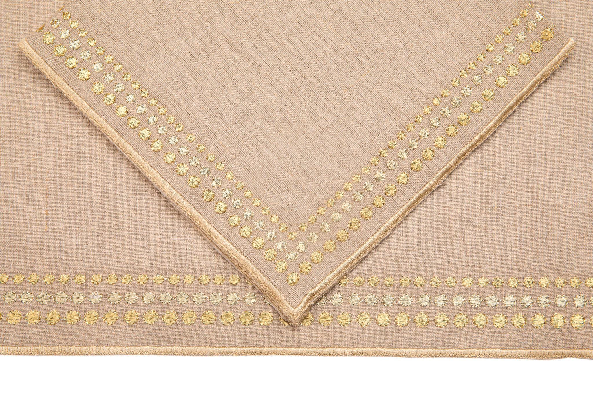 Natural linen placemats and  napkins with delicate  gold embroidery.