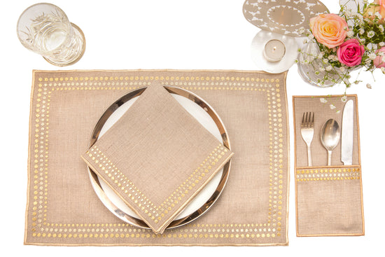 Natural linen placemats and  napkins with delicate  gold embroidery.