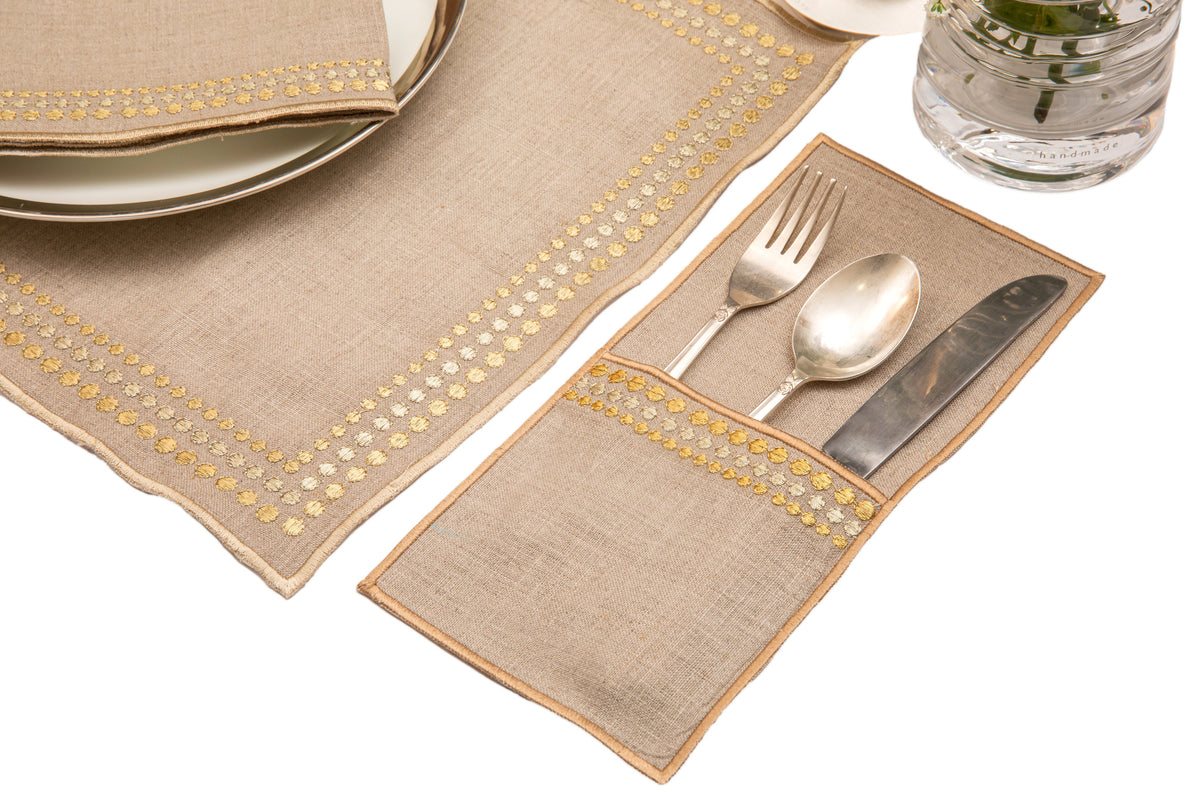 Natural linen placemats and  napkins with delicate  gold embroidery.