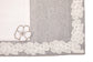 Laced striped placemats  and white linen dinner napkins with floral embroidery.