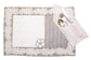 Laced striped placemats  and white linen dinner napkins with floral embroidery.