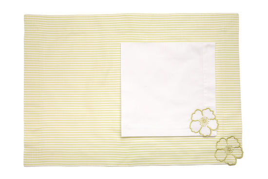 Striped linen placemats and white linen napkins with floral embroidery.