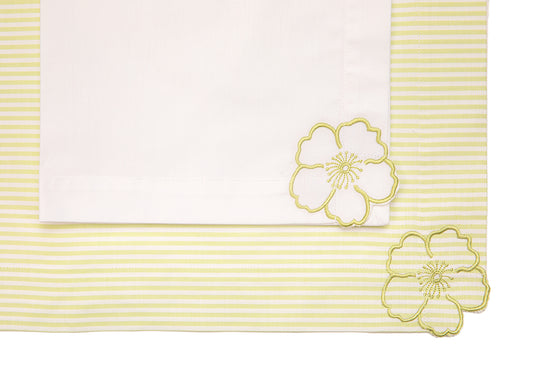 Striped linen placemats and white linen napkins with floral embroidery.