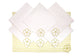 Striped linen placemats and white linen napkins with floral embroidery.