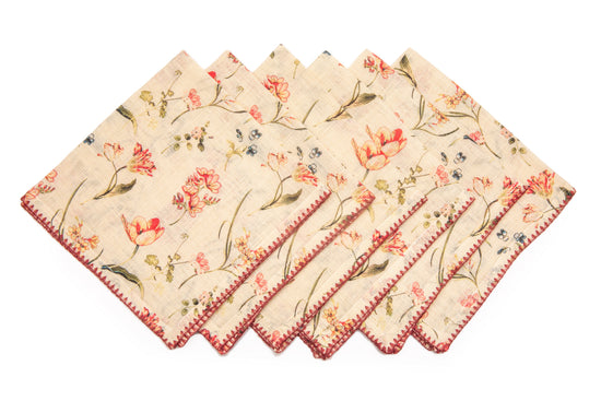 White linen floral printed cocktail napkins with delicate embroidery.