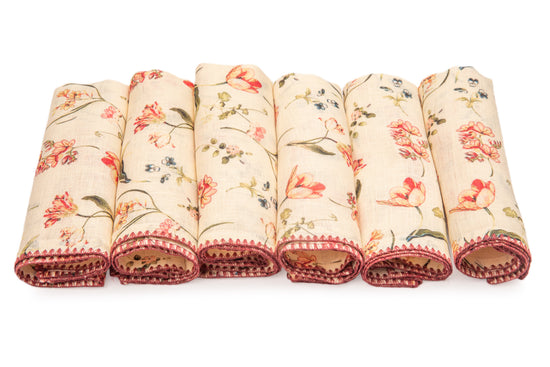 White linen floral printed dinner napkins with delicate embroidery.