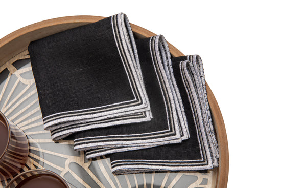 Black linen cocktail embroidered napkins .