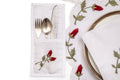 White linen cutlery holder with rosebud embroidery.