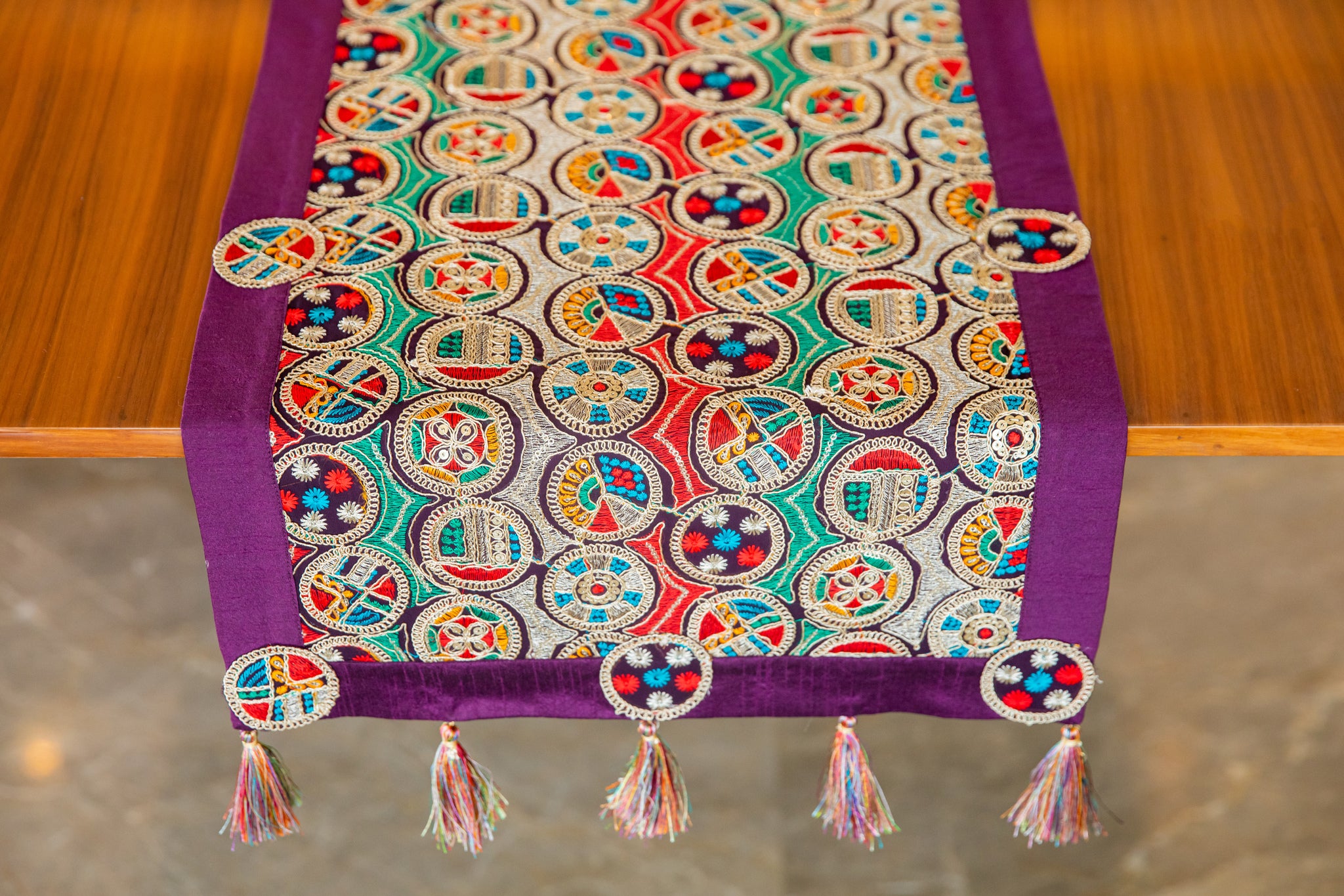 Runner with multicolor circle embroidery.