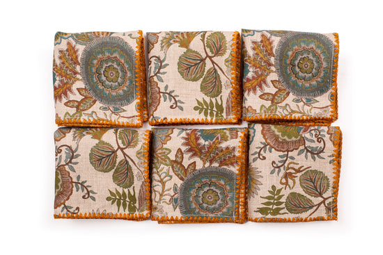 Printed linen cocktail napkin with delicate embroidery.