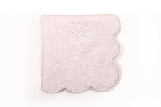 White linen scalloped and embroidered dinner napkin.