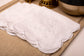White linen scalloped and embroidered dinner napkin.