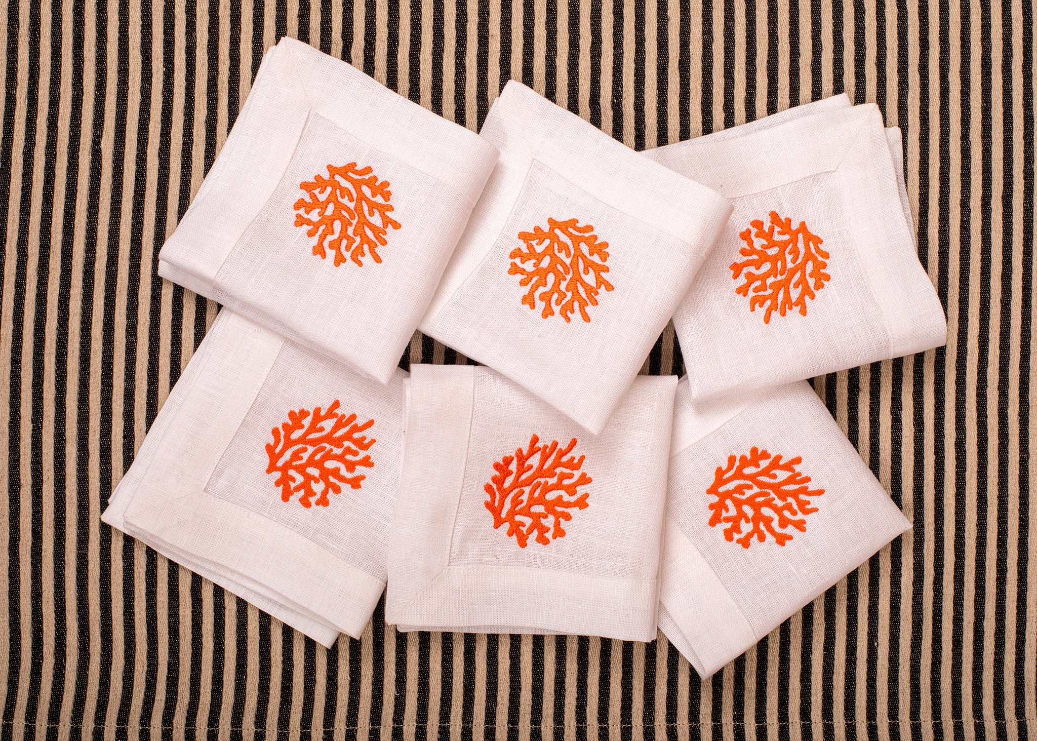 White linen embroidered cocktail napkin.