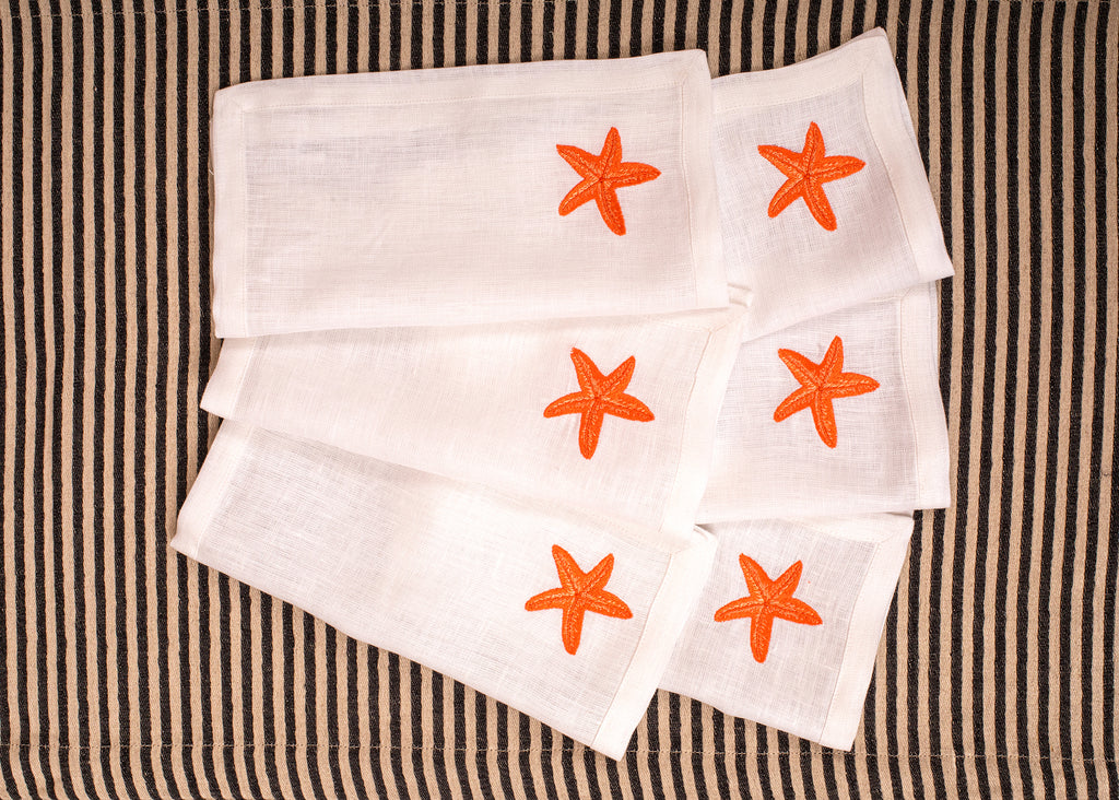 White linen embroidered cocktail napkin.