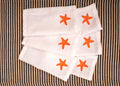 White linen embroidered cocktail napkin.