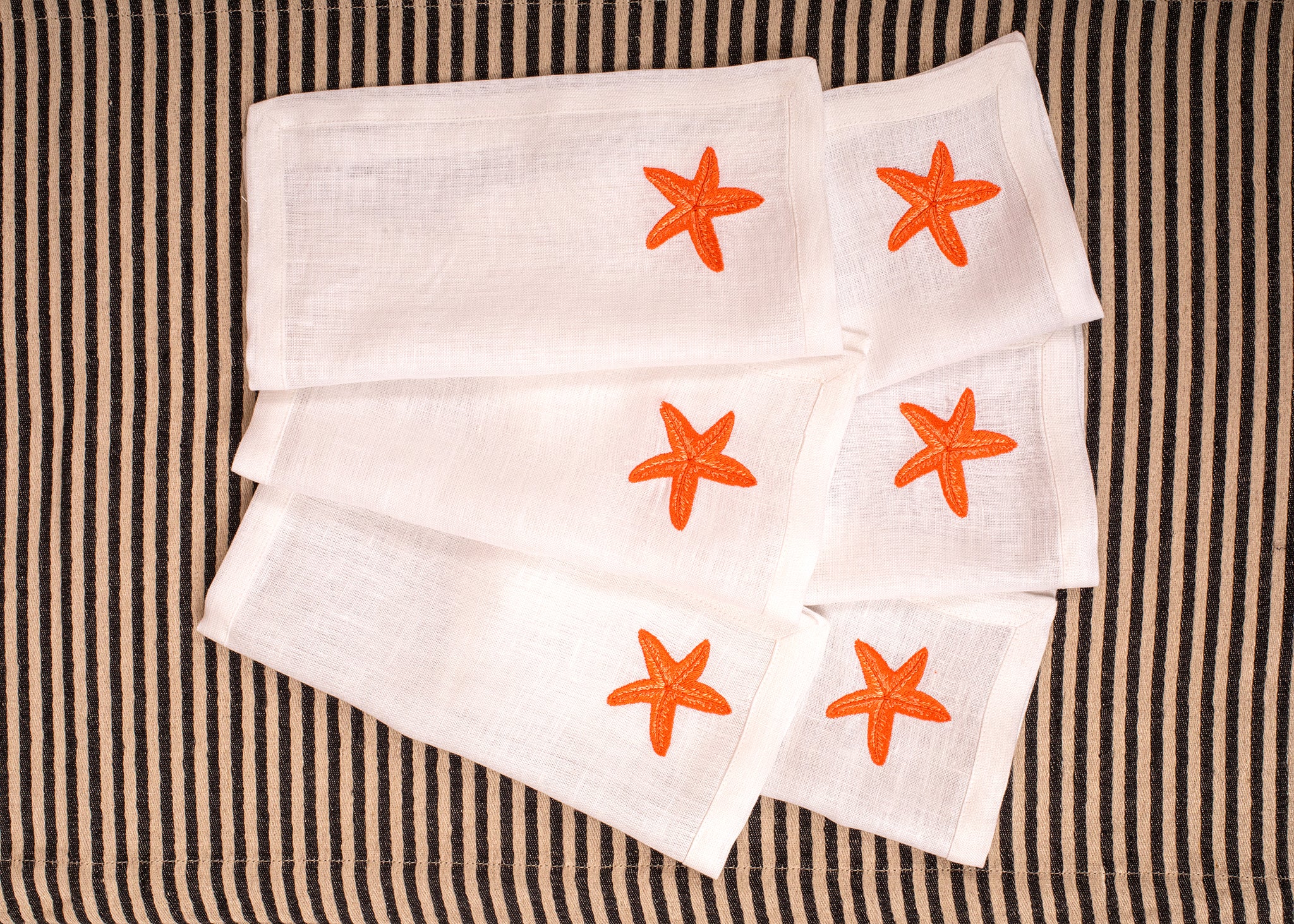 White linen embroidered cocktail napkin.