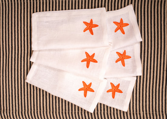 White linen embroidered cocktail napkin.