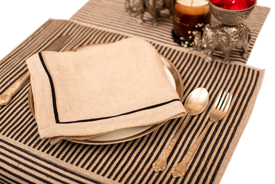 Striped linen placemat and natural linen embroidered napkin.