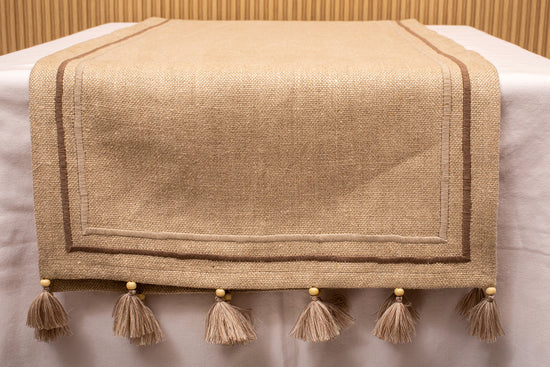 Natural linen  runner with embroidery and tassels.
