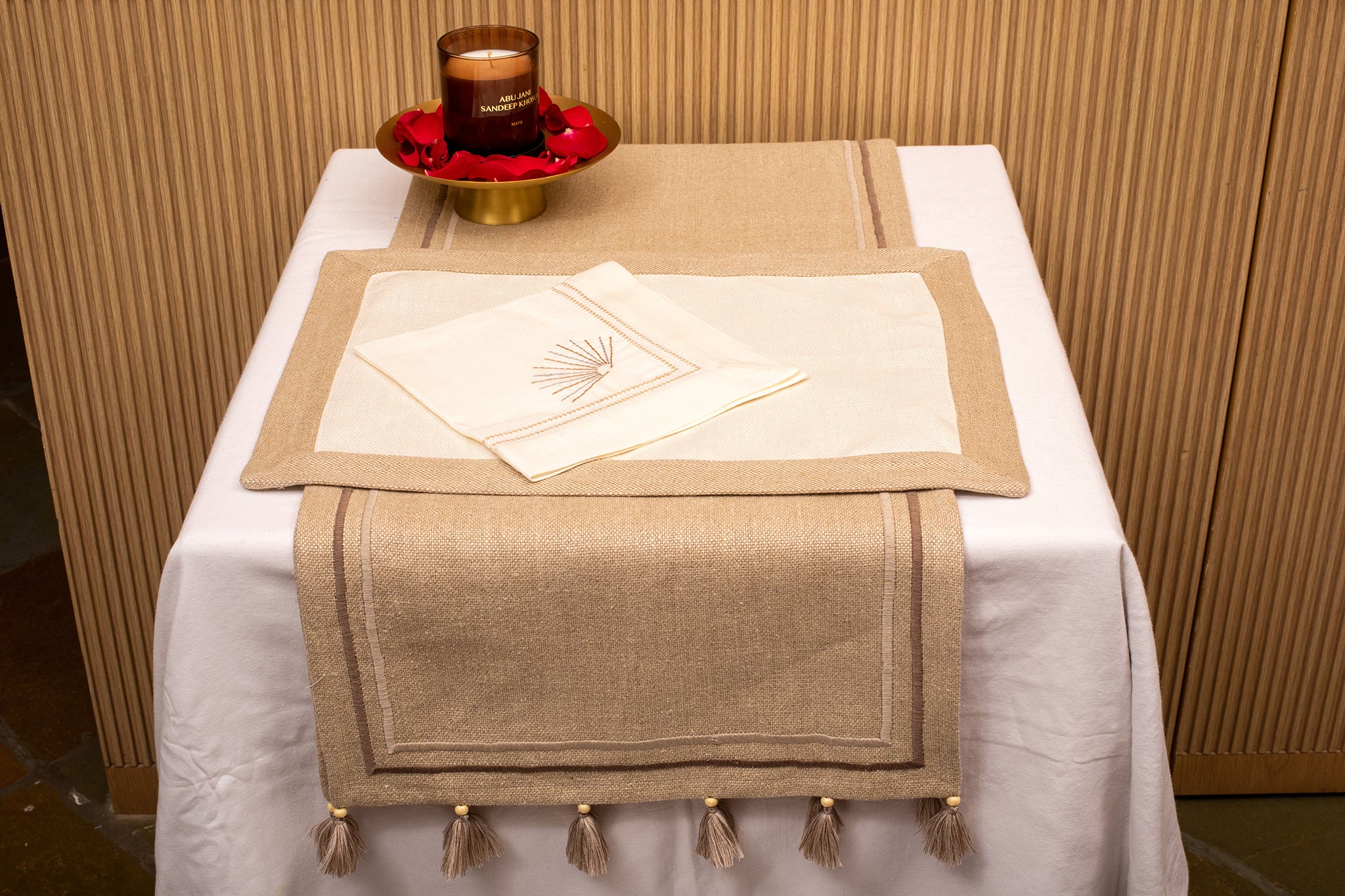 Cream linen placemat with  cream linen embroidered napkin.