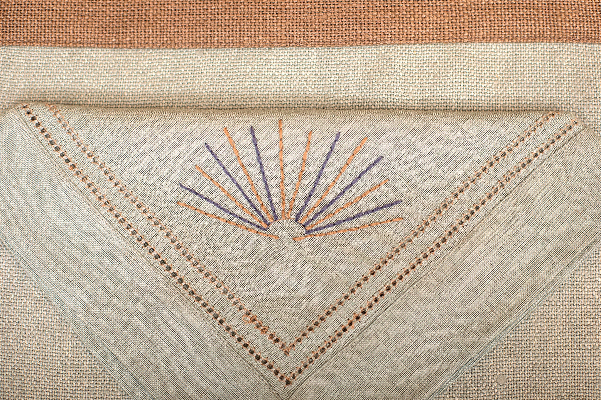 Slate blue linen  placemat with slate blue embroidered napkin.