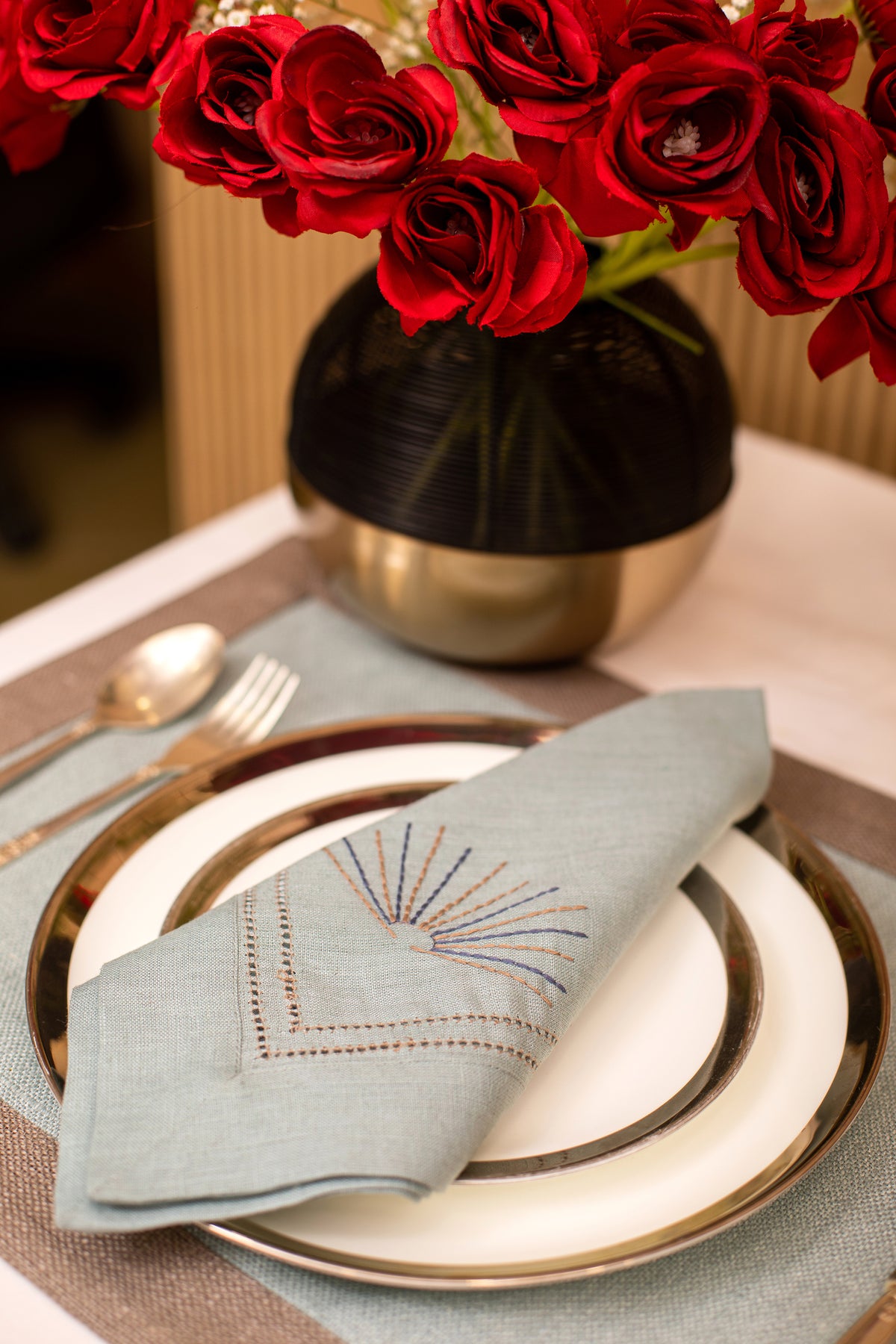 Slate blue linen  placemat with slate blue embroidered napkin.